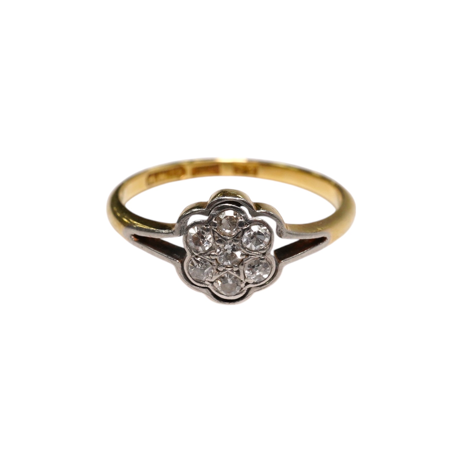 A 1940's 18ct, plat and diamond set flower head cluster ring, size O, gross weight 2.1 grams.